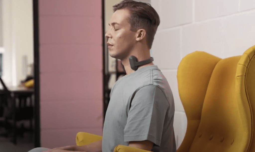 man relaxing wearing the pulsetto vns device around his neck, meditating