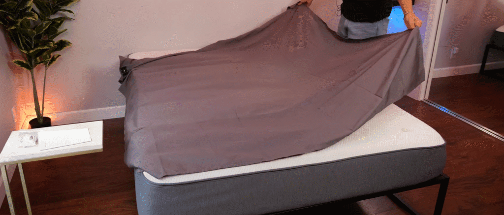 putting a grounding sheet on the bed