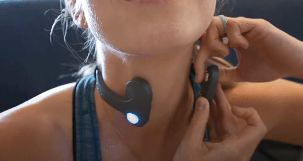 Woman applying conductive gel to the Pulsetto vagus nerve stimulator device before use
