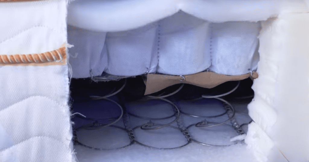 Cross-section cutaway showing the dual coil layers inside the Saatva Classic